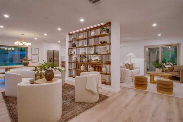 interior space featuring a notable chandelier and light wood-type flooring