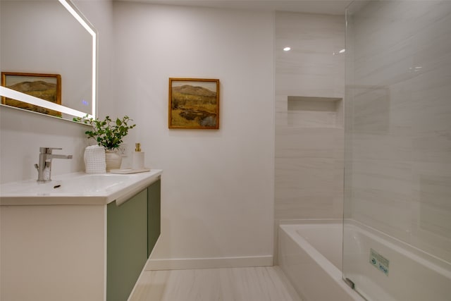 bathroom featuring vanity and tiled shower / bath combo