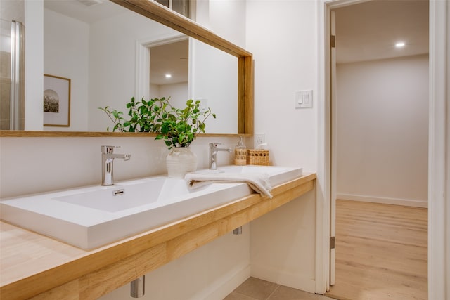 bathroom with vanity and hardwood / wood-style floors