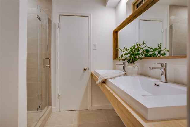 bathroom with tile patterned flooring and walk in shower