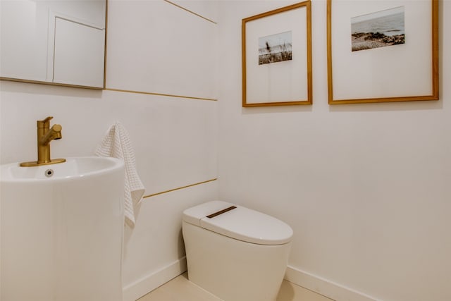 bathroom with tile patterned floors and toilet