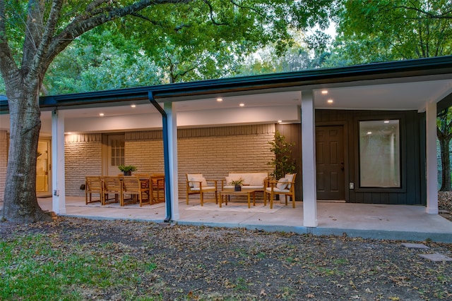 exterior space featuring an outdoor hangout area and a patio