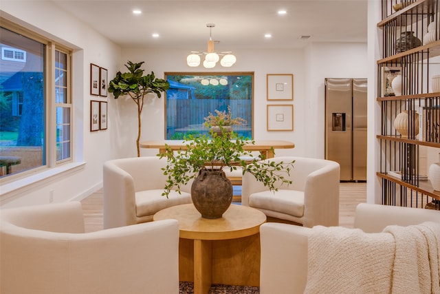 living room featuring a notable chandelier and wood-type flooring