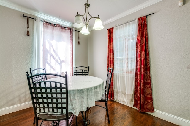 dining room featuring ornamental molding, an inviting chandelier, and dark wood-type flooring