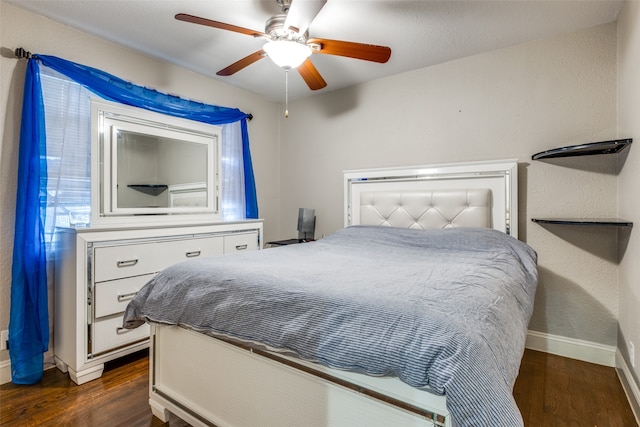 bedroom featuring ceiling fan and dark hardwood / wood-style floors