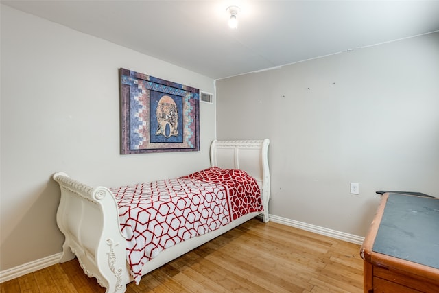 bedroom with wood-type flooring