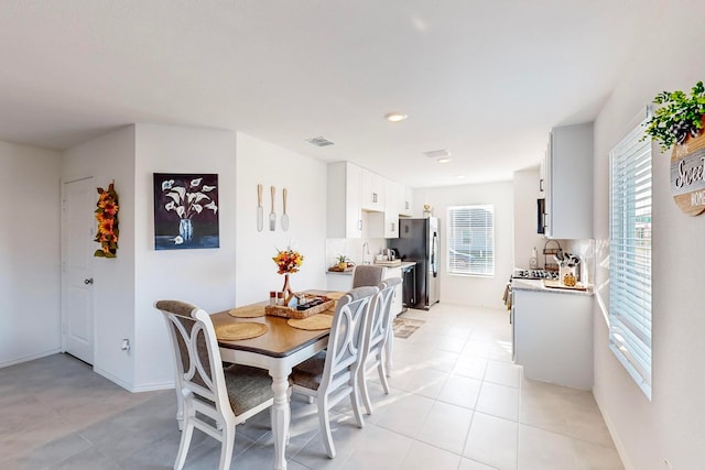 dining area featuring light tile patterned floors