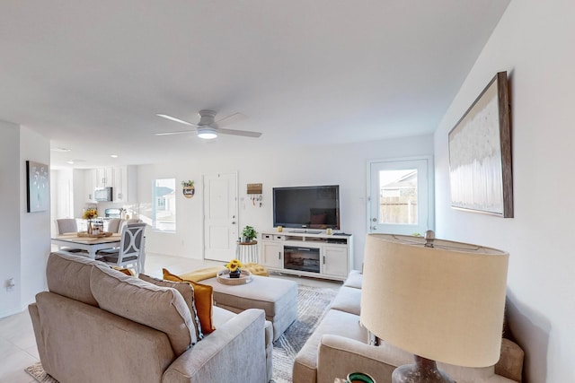 tiled living room featuring plenty of natural light and ceiling fan