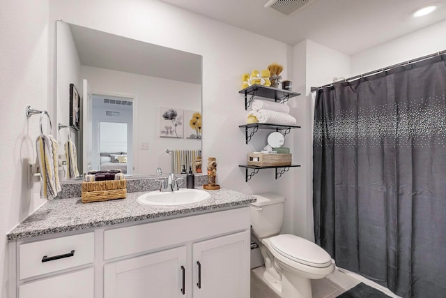 bathroom featuring walk in shower, vanity, and toilet