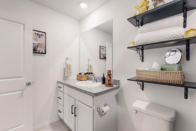 bathroom featuring tile patterned floors, vanity, and toilet