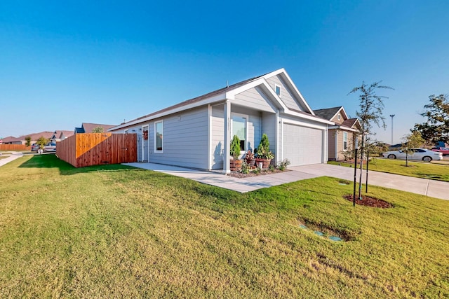 ranch-style house featuring a front yard and a garage