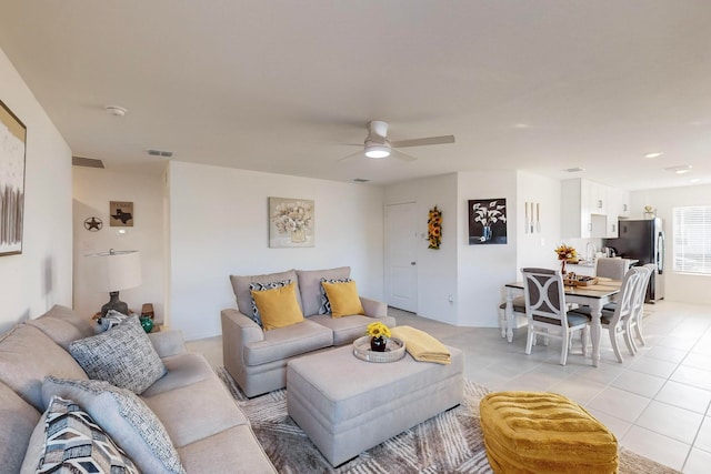 living room with light tile patterned floors and ceiling fan