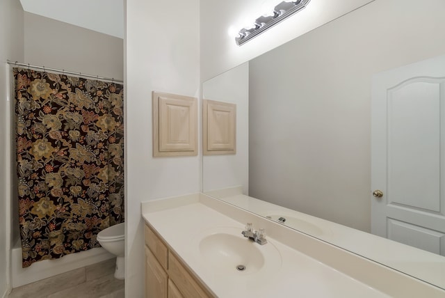 full bathroom featuring tile patterned floors, vanity, toilet, and shower / bath combo with shower curtain