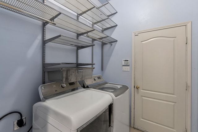 clothes washing area with washing machine and clothes dryer