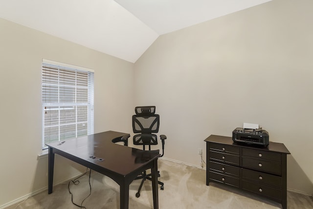 office area with a healthy amount of sunlight, light colored carpet, and lofted ceiling