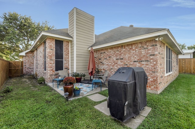 rear view of property with a patio area and a yard