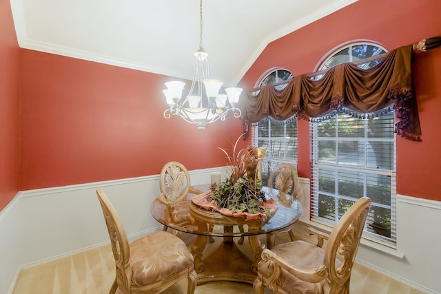 carpeted dining room with a chandelier, crown molding, and vaulted ceiling