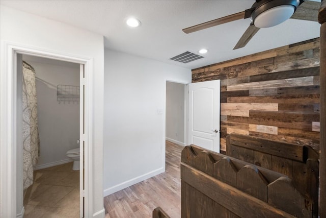 living room featuring ceiling fan and light hardwood / wood-style flooring