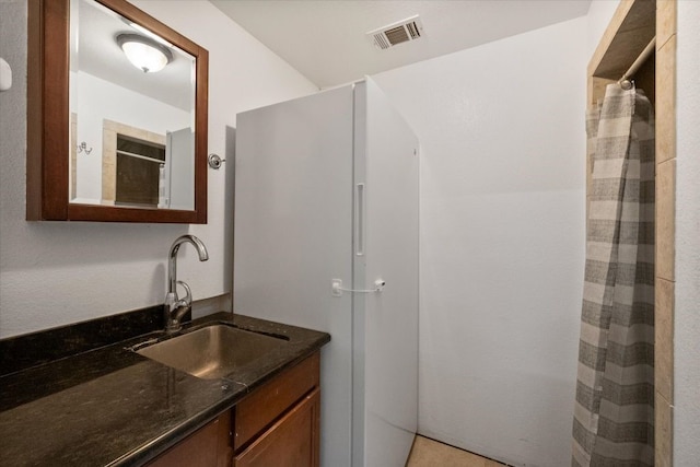 bathroom with vanity and walk in shower