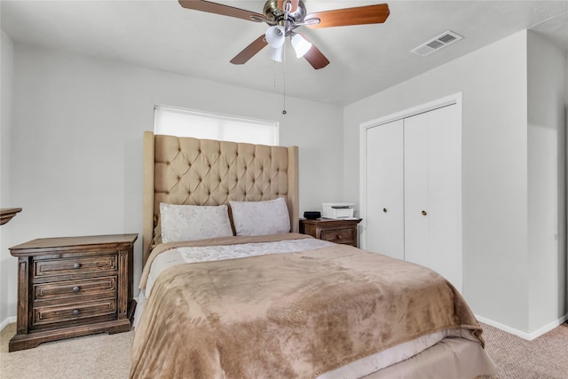 carpeted bedroom featuring a closet and ceiling fan