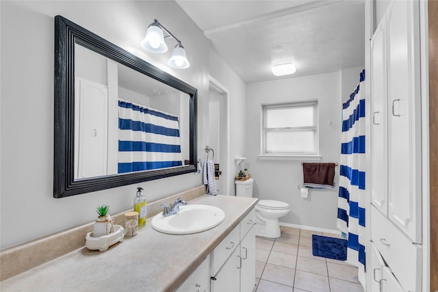 bathroom featuring tile patterned flooring, vanity, and toilet