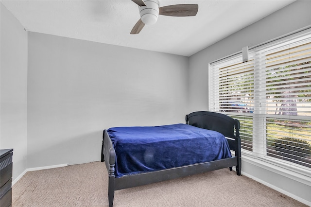 bedroom featuring ceiling fan and light colored carpet