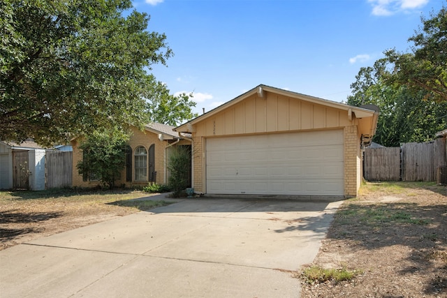 single story home with an outbuilding and a garage