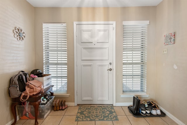 entryway featuring light tile patterned flooring and plenty of natural light