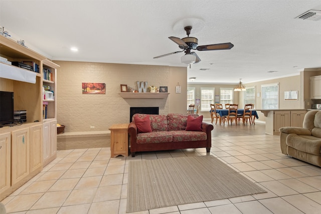 tiled living room featuring ornamental molding and ceiling fan