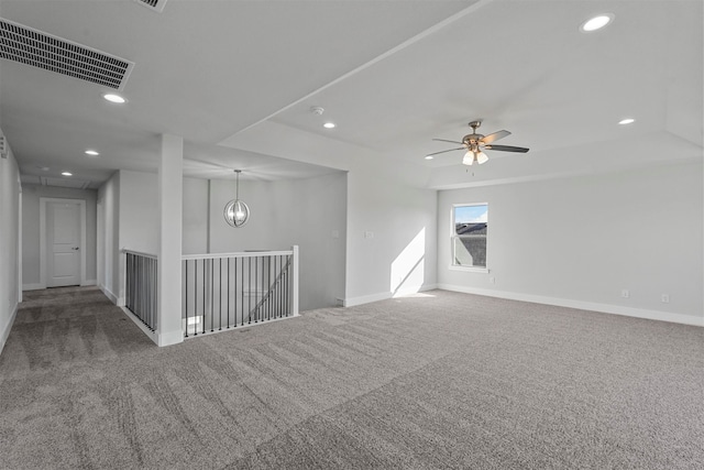 unfurnished room with ceiling fan with notable chandelier and carpet flooring