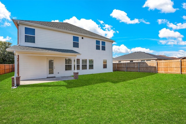 back of house featuring a patio and a lawn