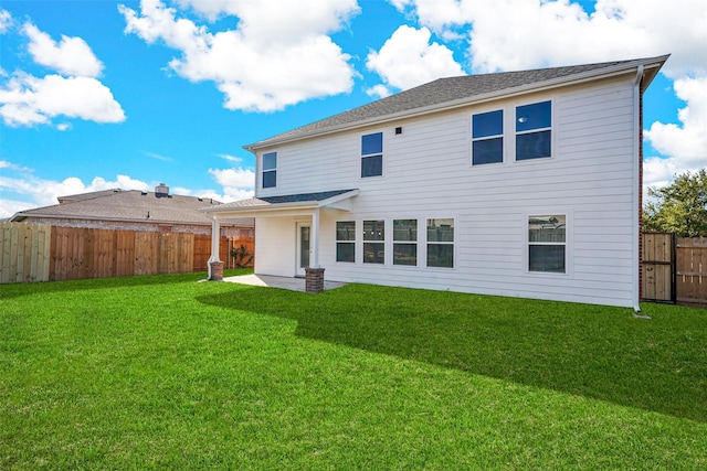 back of house with a patio area and a lawn