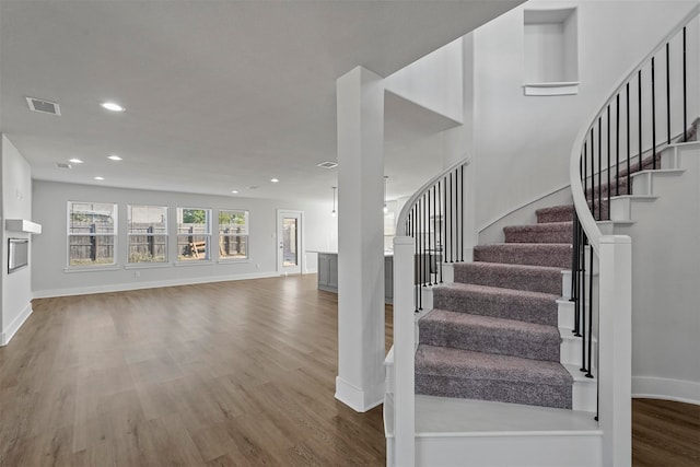 stairs featuring hardwood / wood-style flooring