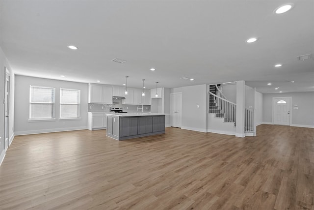 unfurnished living room with light hardwood / wood-style flooring