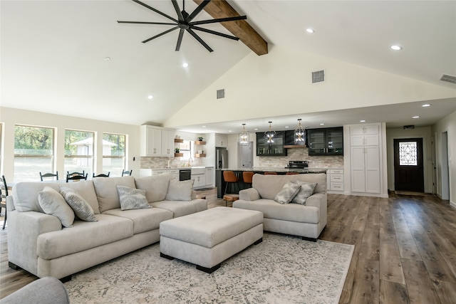 living room with wood-type flooring, high vaulted ceiling, and beam ceiling