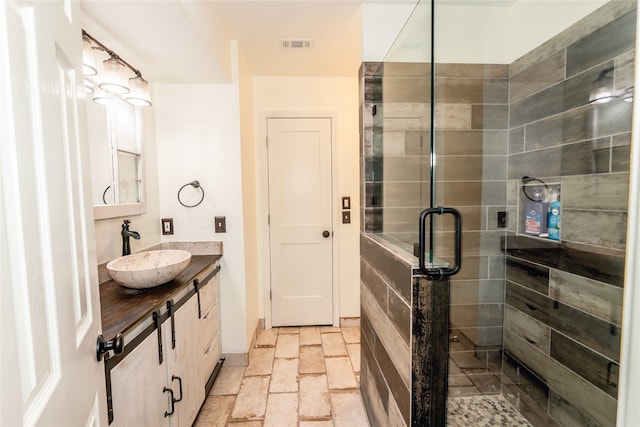 bathroom with walk in shower and vanity