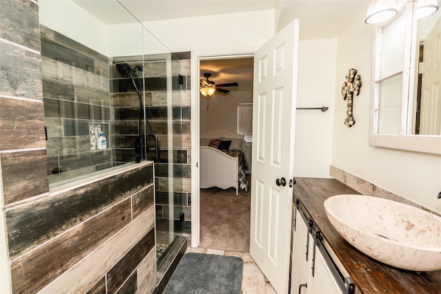 bathroom featuring an enclosed shower, vanity, and ceiling fan