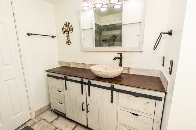 bathroom featuring an enclosed shower and vanity