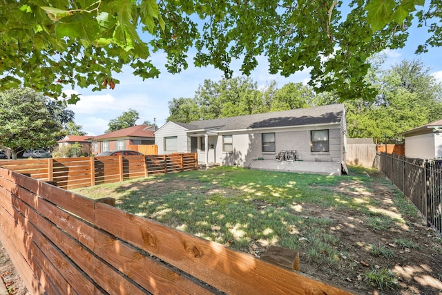 back of property featuring a patio and a lawn