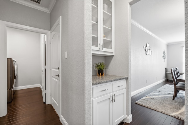 hall featuring crown molding, dark hardwood / wood-style flooring, and independent washer and dryer