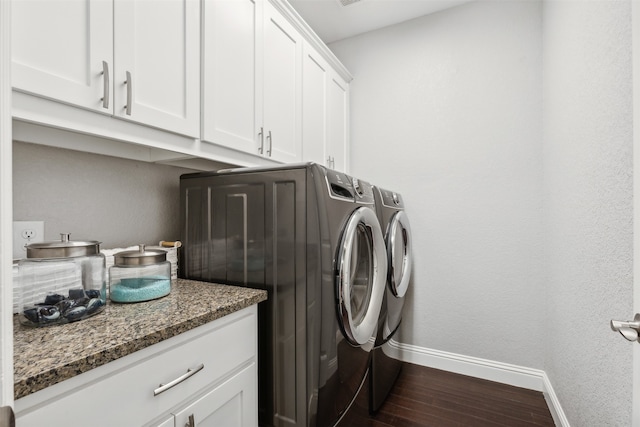 washroom featuring cabinets, dark hardwood / wood-style floors, and independent washer and dryer