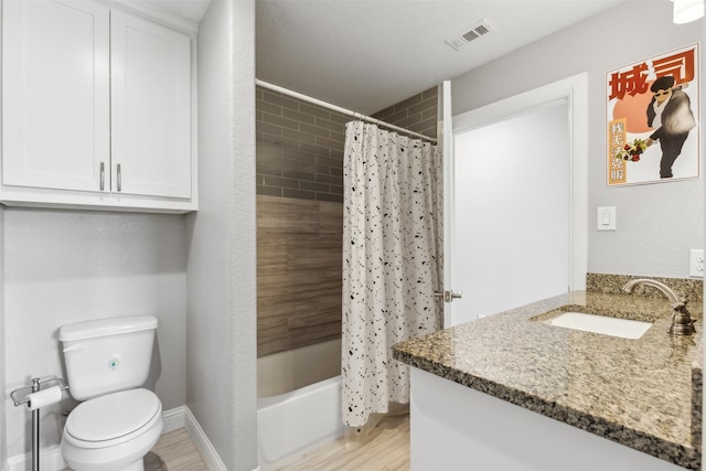 full bathroom with hardwood / wood-style flooring, vanity, shower / tub combo, and toilet