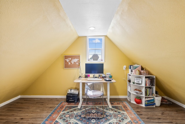 office space featuring a textured ceiling, hardwood / wood-style floors, and vaulted ceiling