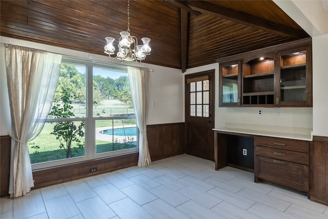 interior space featuring wood ceiling, a notable chandelier, lofted ceiling, and wood walls