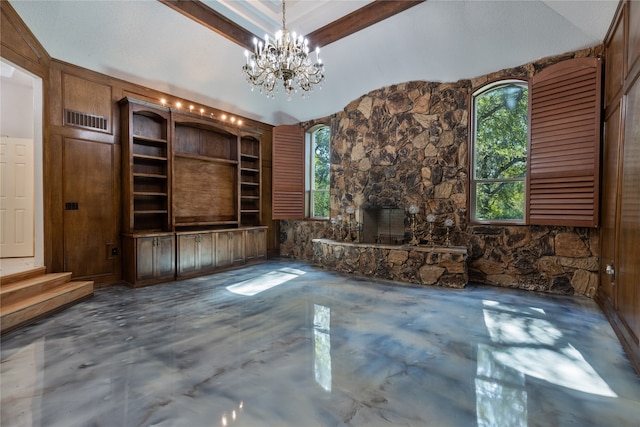 unfurnished living room featuring concrete floors, built in features, a stone fireplace, lofted ceiling with beams, and wooden walls