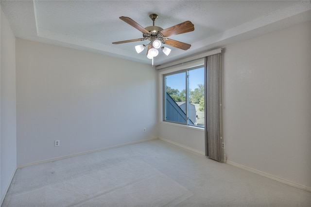 unfurnished room featuring light carpet, a textured ceiling, and ceiling fan