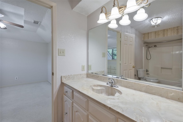 full bathroom featuring visible vents, a ceiling fan, toilet, a textured ceiling, and vanity