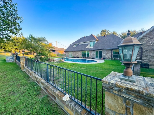 view of yard with a fenced in pool and fence