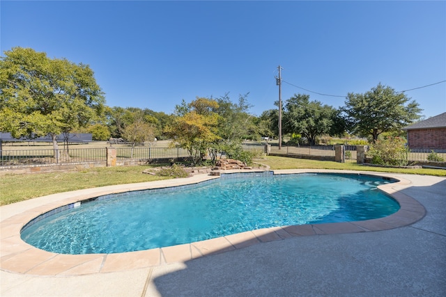 view of pool with a lawn