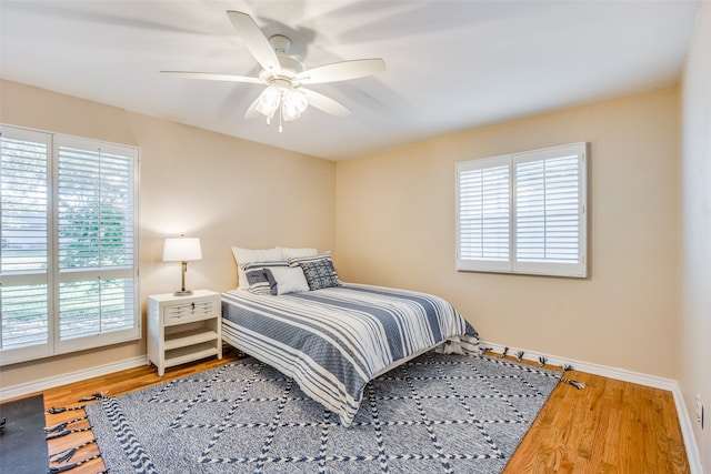 bedroom with ceiling fan and hardwood / wood-style flooring